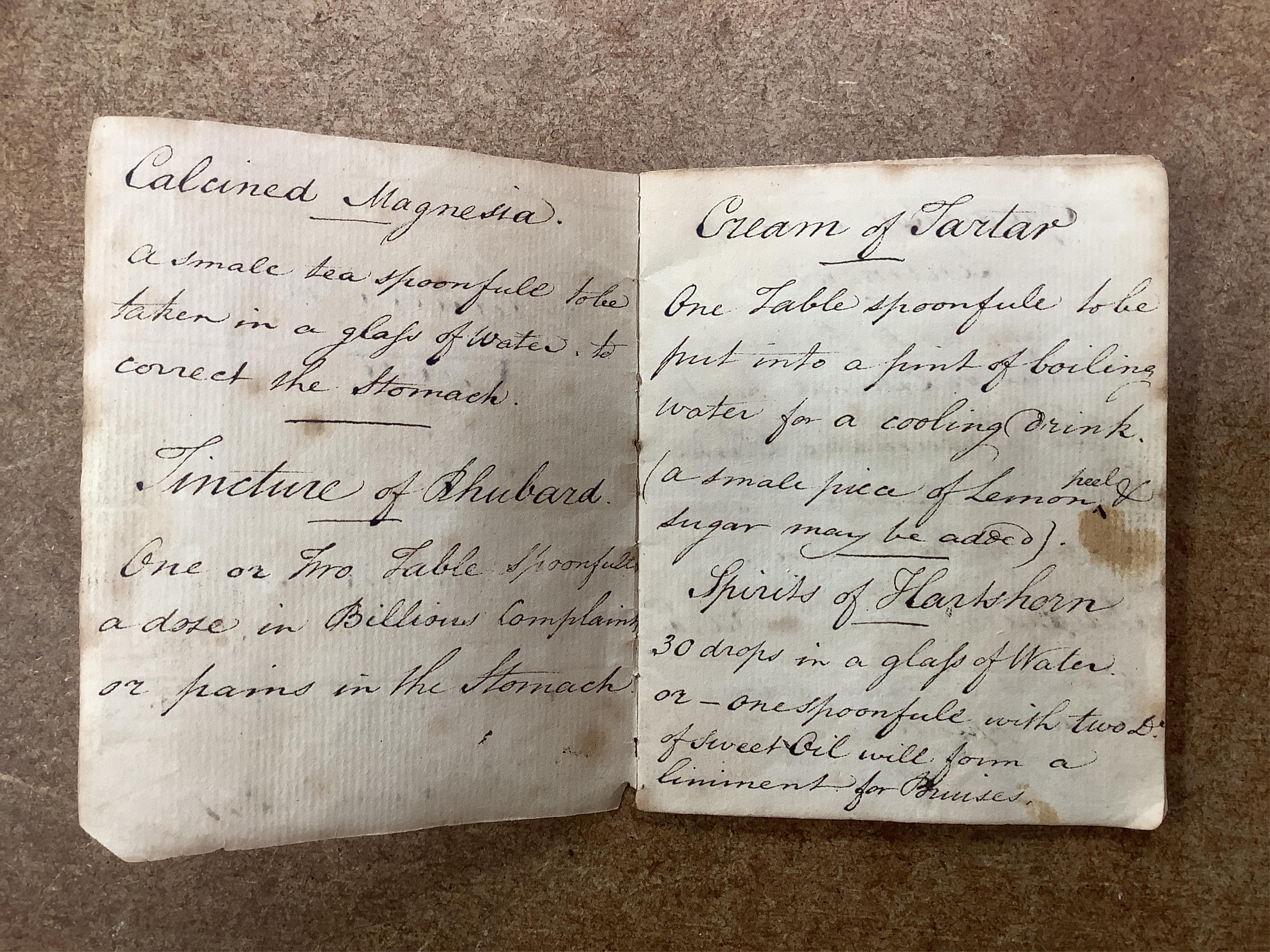 A 19th century mahogany apothecary cabinet, interior with fitting compartments containing twenty-one glass bottles, most with stoppers, five drawers with ivory knobs containing a miniature pestle and water, mixing glasse